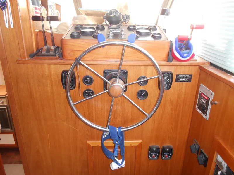 Slide: The Image of 1989 Cooper Marine Prowler 9m boat helm with wooden dashboard and steering wheel. - 21