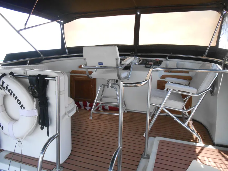 Slide: The Image of Interior of 1989 Cooper Marine Prowler 9m boat with seating and steering wheel. - 3
