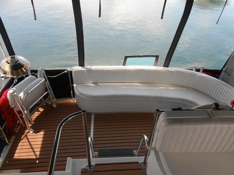 Slide: The Image of Interior of 1989 Cooper Marine Prowler 9m with white seating and wooden flooring. - 5