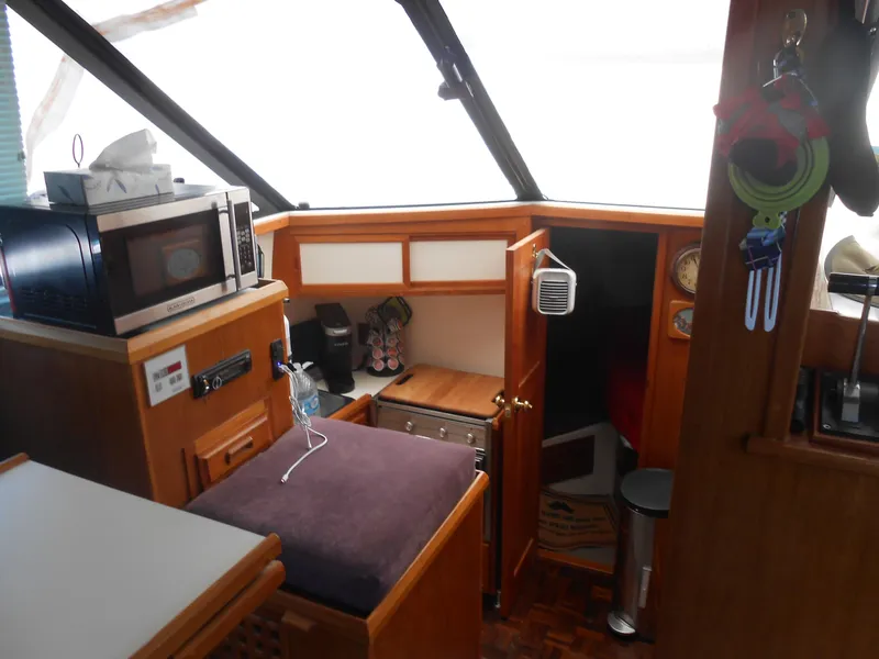 Slide: The Image of Interior of 1989 Cooper Marine Prowler 9m boat with microwave and storage compartments. - 6