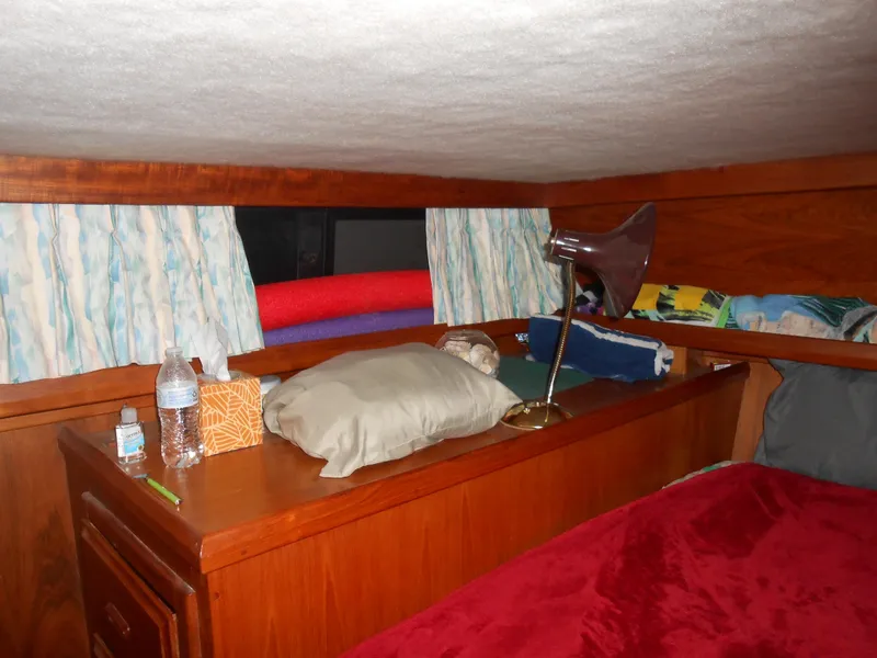 Slide: The Image of Cozy cabin interior of 1989 Cooper Marine Prowler 9m with wooden furnishings. - 9