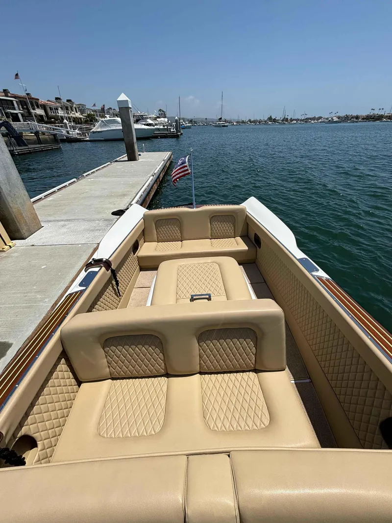 Slide: The Image of 1960 Chris-Craft Continental Gull Wing boat with tan interior, docked by a marina. - 10