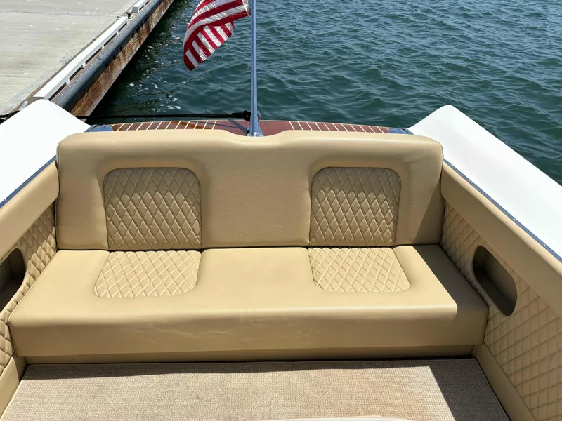 Slide: The Image of 1960 Chris-Craft Continental Gull Wing boat with beige quilted seating and American flag. - 11
