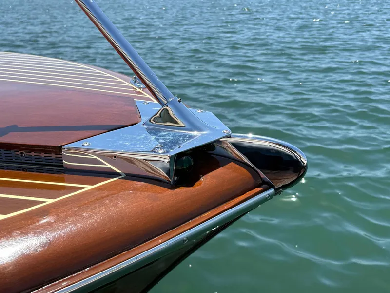 Slide: The Image of 1960 Chris-Craft Continental Gull Wing boat detail on water, showcasing polished wood and chrome. - 6