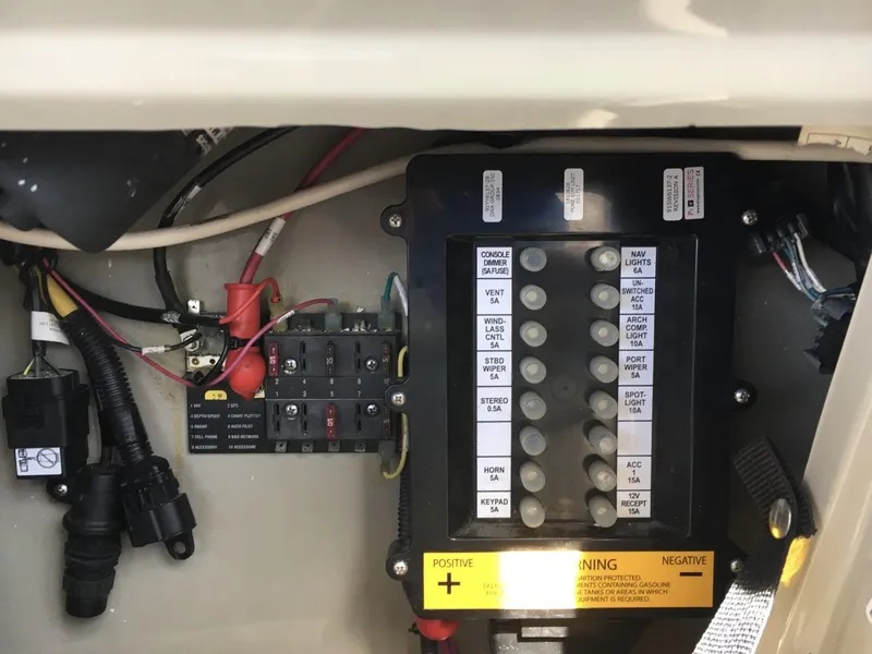 Slide: The Image of Electrical panel of a 2010 Sea Ray 330 Sundancer boat, showing wiring and circuit breakers. - 12
