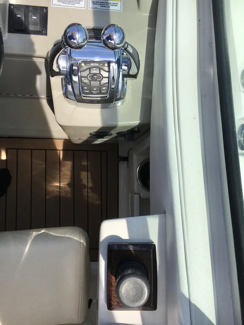 Slide: The Image of Control panel of a 2010 Sea Ray 330 Sundancer boat with chrome throttle levers. - 13