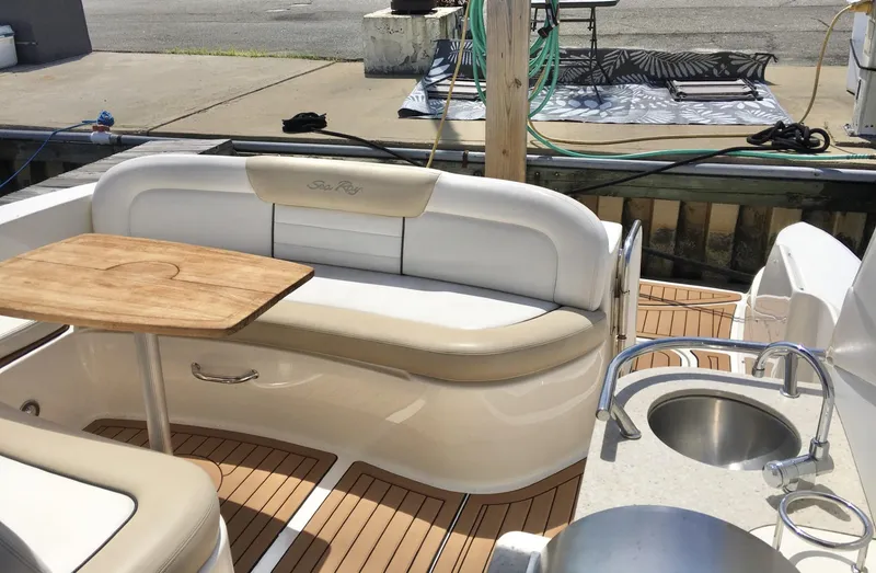 Slide: The Image of Luxury seating area on 2010 Sea Ray 330 Sundancer yacht with wooden table and sink. - 16