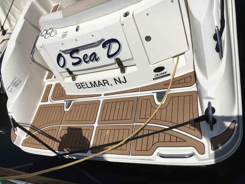 Slide: The Image of 2010 Sea Ray 330 Sundancer boat docked in Belmar, NJ, with custom deck design. - 2
