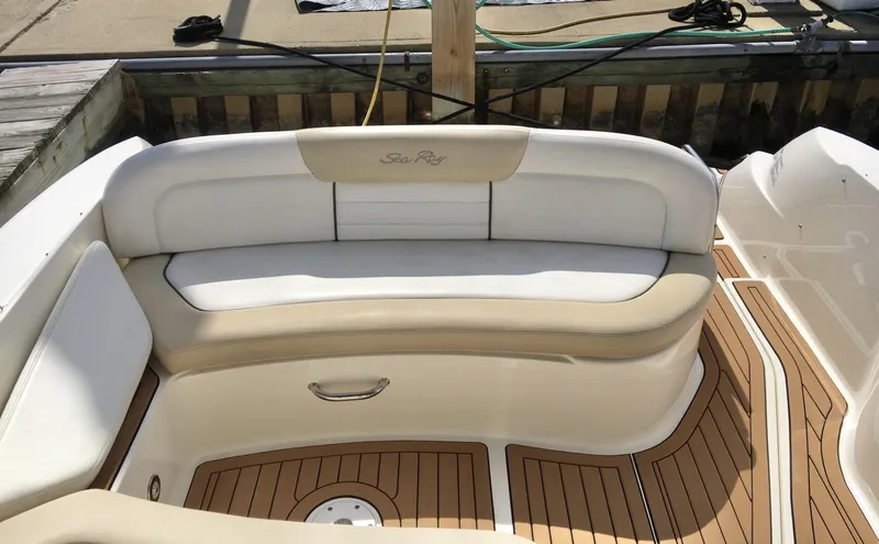 Slide: The Image of 2010 Sea Ray 330 Sundancer boat with cushioned seating and teak flooring. - 20