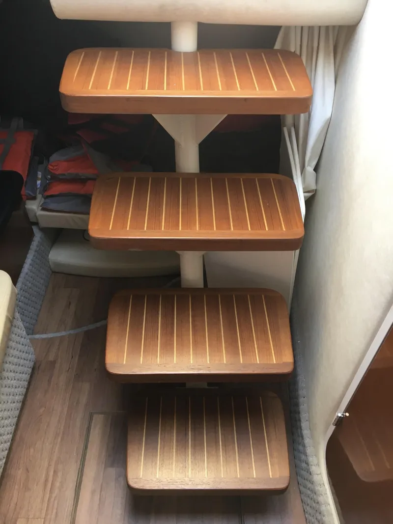 Slide: The Image of Wooden steps inside a 2010 Sea Ray 330 Sundancer boat cabin. - 22