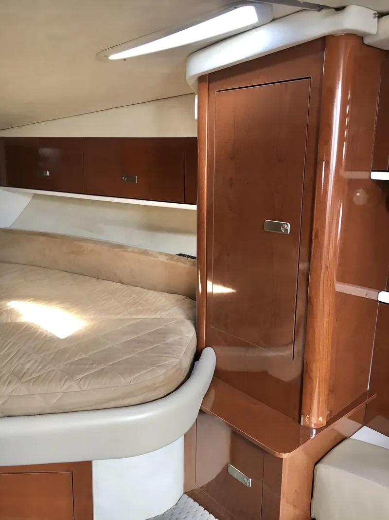 Slide: The Image of Interior cabin of 2010 Sea Ray 330 Sundancer with wood finish and cozy bed. - 25