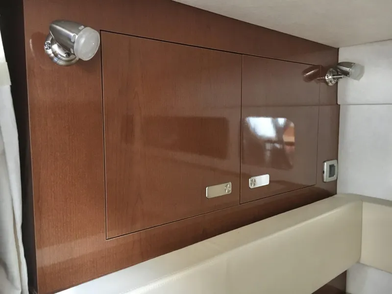 Slide: The Image of Interior of 2010 Sea Ray 330 Sundancer with wooden cabinetry and modern lighting. - 28