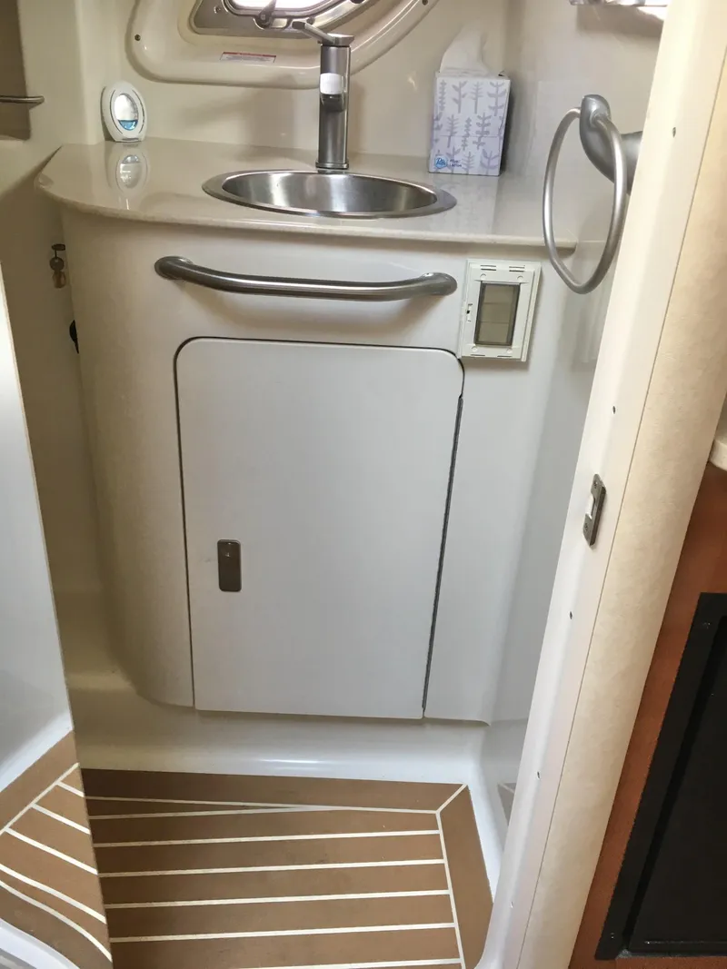 Slide: The Image of 2010 Sea Ray 330 Sundancer bathroom with sink, cabinet, and modern fixtures. - 31