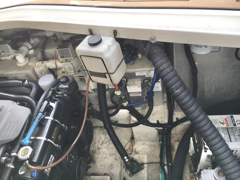 Slide: The Image of Engine compartment of a 2010 Sea Ray 330 Sundancer boat, showing various mechanical components. - 35