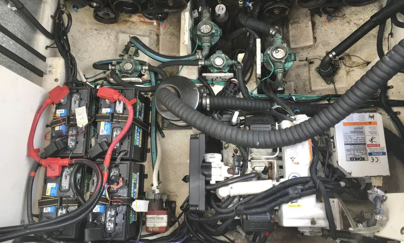 Slide: The Image of Engine compartment of a 2010 Sea Ray 330 Sundancer with visible batteries and wiring. - 37