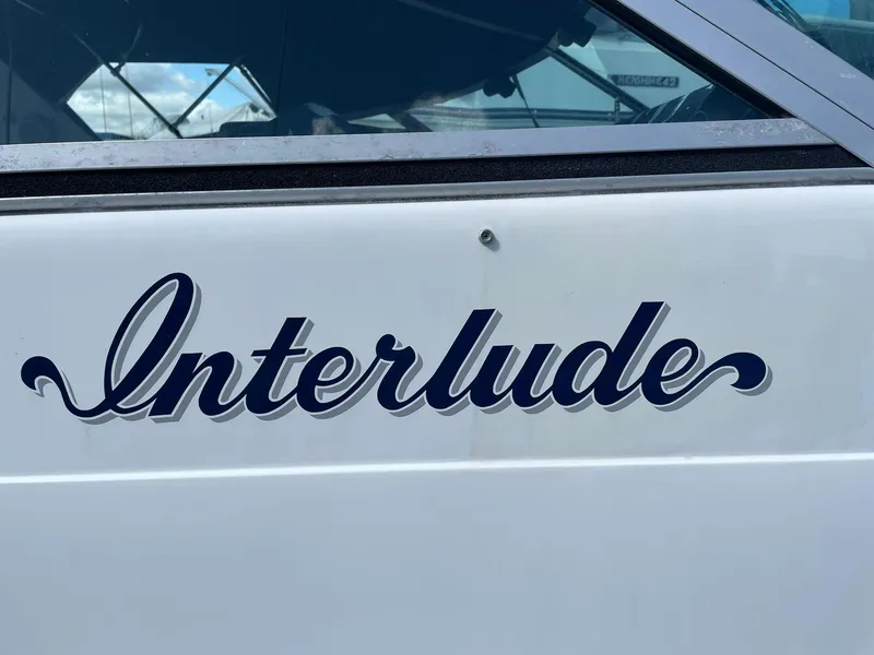 Slide: The Image of Sea Ray 420 boat named "Interlude," 1989 model, white exterior with elegant lettering. - 10