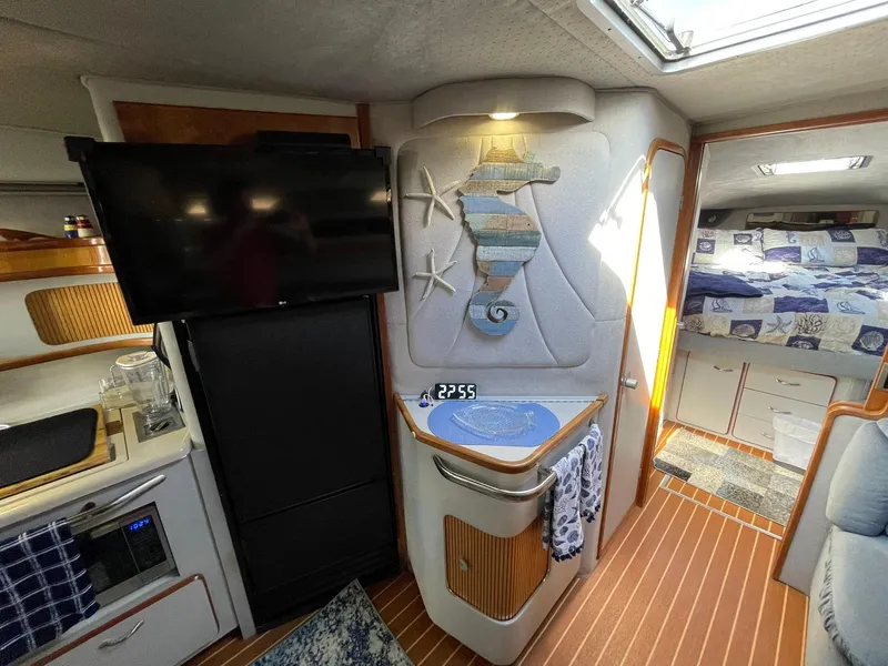 Slide: The Image of Interior of 1989 Sea Ray 420 yacht with modern amenities and nautical decor. - 22