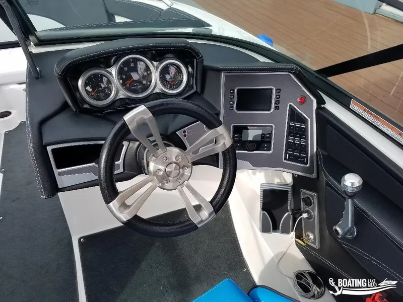Slide: The Image of 2018 MasterCraft XT 22 boat dashboard with steering wheel and control panel. - 10