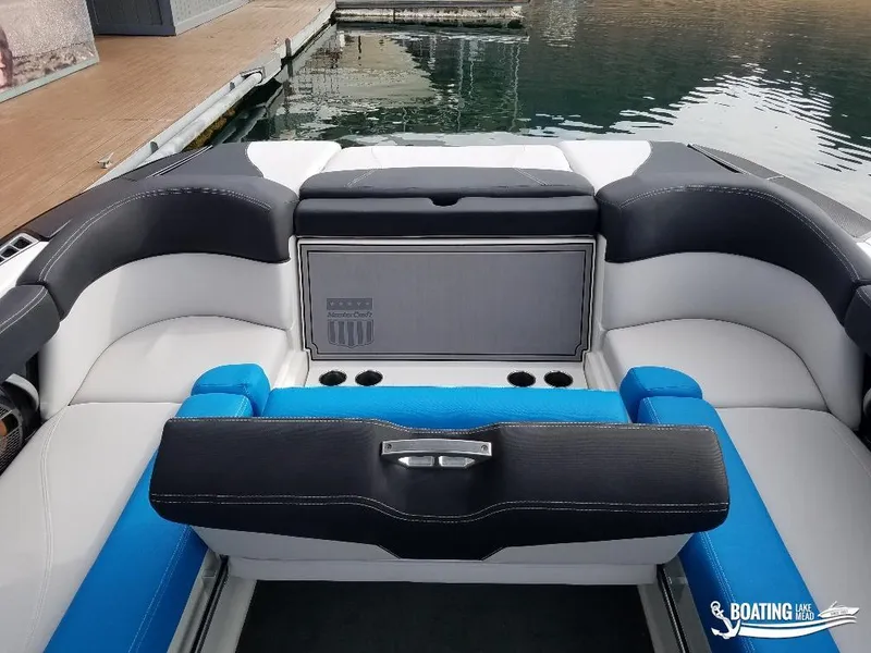 Slide: The Image of 2018 MasterCraft XT 22 boat interior with seating and cup holders. - 13