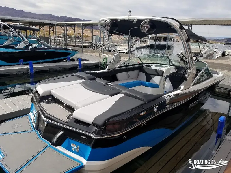 Slide: The Image of 2018 MasterCraft XT 22 boat docked at marina, rear view. - 6