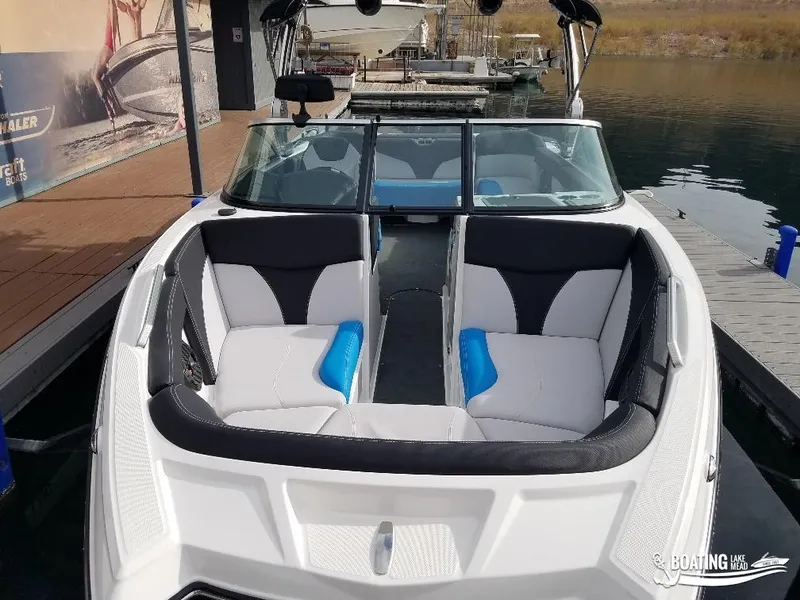 Slide: The Image of 2018 MasterCraft XT 22 boat docked, featuring spacious seating and modern design. - 8