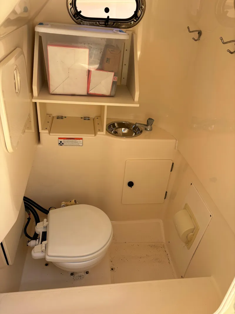 Slide: The Image of 2008 Pursuit S 310 Sport boat interior bathroom with toilet and sink. - 14