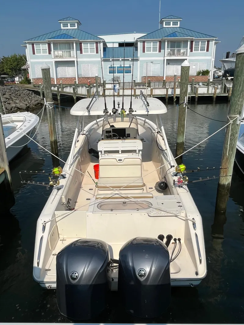Slide: The Image of 2008 Pursuit S 310 Sport boat docked at marina with twin engines. - 6