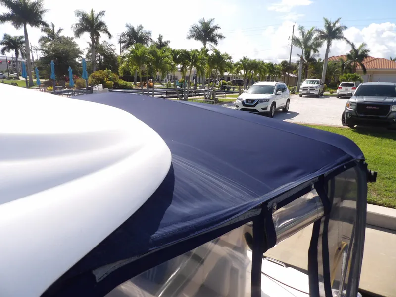 Slide: The Image of 2005 Sea Ray 390 Sundancer with blue canvas top in marina parking lot. - 13