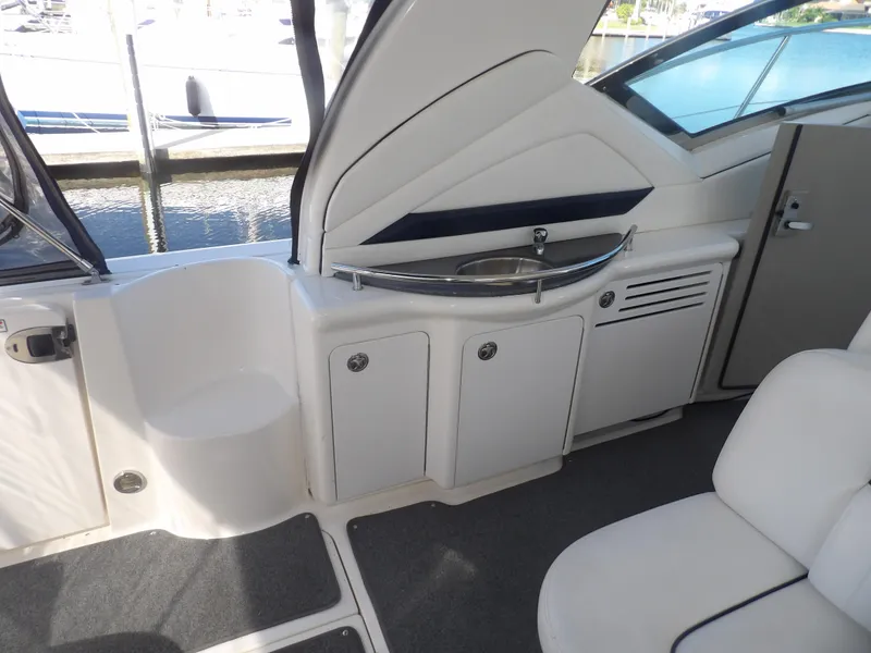 Slide: The Image of 2005 Sea Ray 390 Sundancer cockpit with storage cabinets and sink. - 17
