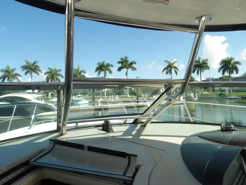 Slide: The Image of View from the helm of a 2005 Sea Ray 390 Sundancer yacht in a marina. - 31