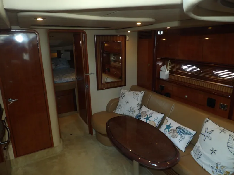 Slide: The Image of Interior of 2005 Sea Ray 390 Sundancer yacht with seating area and table. - 32