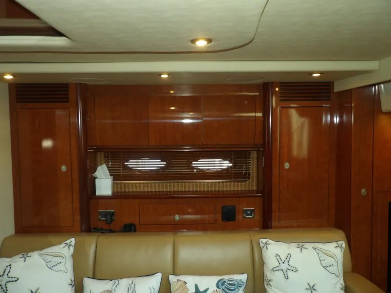Slide: The Image of Interior of 2005 Sea Ray 390 Sundancer with wooden cabinetry and beige seating. - 33