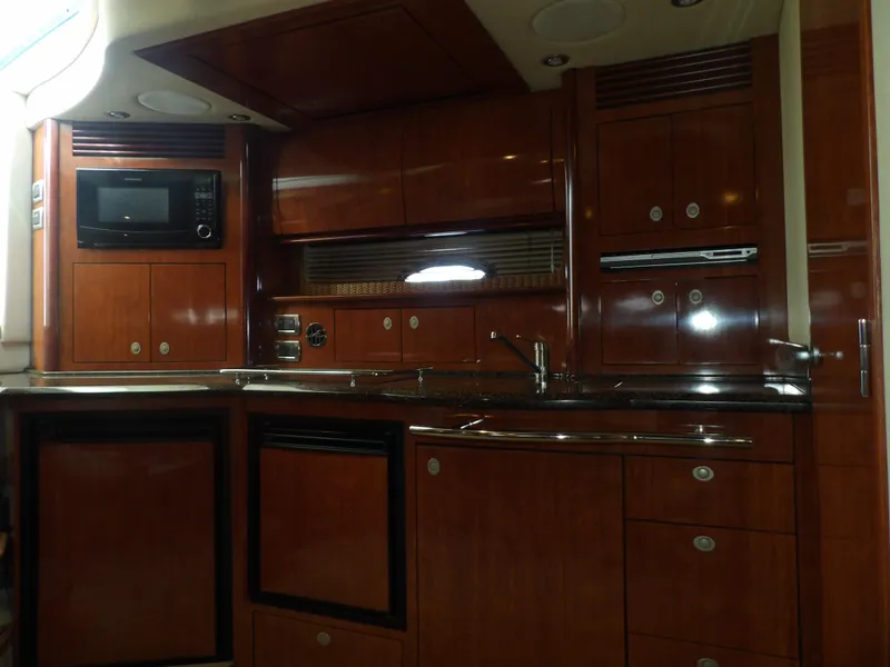 Slide: The Image of Interior kitchen of 2005 Sea Ray 390 Sundancer yacht with wooden cabinets and modern appliances. - 35