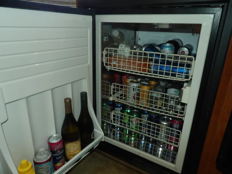 Slide: The Image of Mini fridge stocked with beverages on a 2005 Sea Ray 390 Sundancer boat. - 45