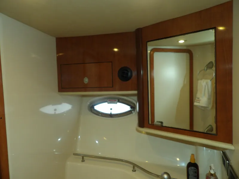 Slide: The Image of 2005 Sea Ray 390 Sundancer bathroom with wooden cabinets and mirror. - 47