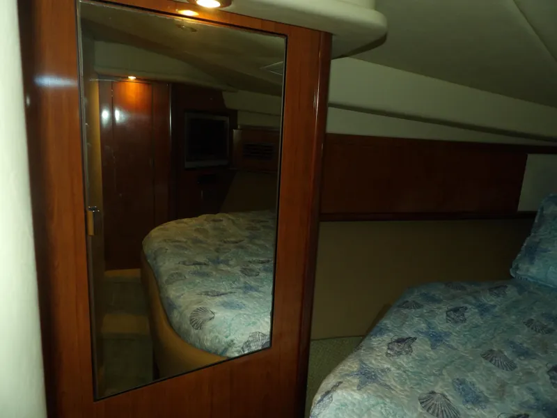 Slide: The Image of Interior cabin of 2005 Sea Ray 390 Sundancer with mirrored closet and bed. - 49