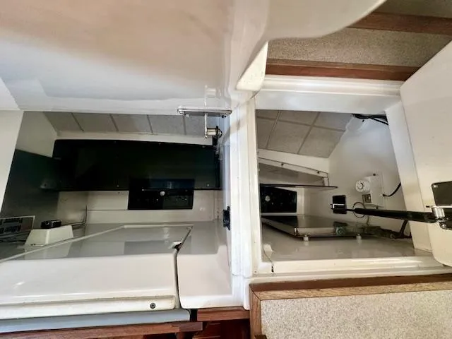 Slide: The Image of Interior view of a 1993 Hunter Legend 40.5 sailboat, showcasing storage compartments. - 18