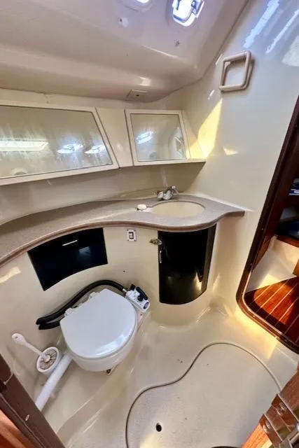 Slide: The Image of 1993 Hunter Legend 40.5 yacht bathroom with modern fixtures and storage cabinets. - 27