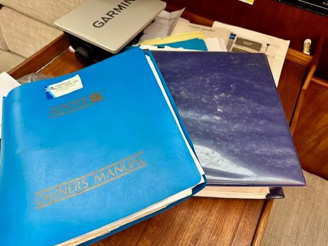 Slide: The Image of Owner's manuals for 1993 Hunter Legend 40.5 sailboat on wooden desk. - 39