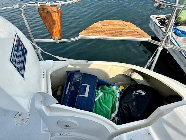 Slide: The Image of Open storage compartment on 1993 Hunter Legend 40.5 sailboat with gear and water view. - 7