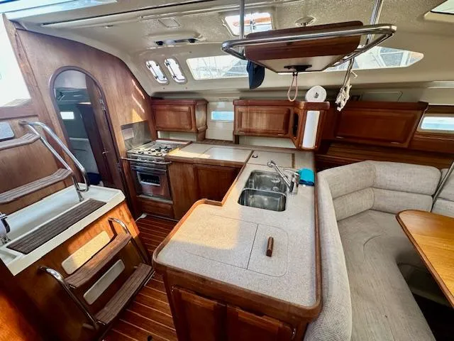 Slide: The Image of Interior of 1993 Hunter Legend 40.5 sailboat with kitchen and seating area. - 9