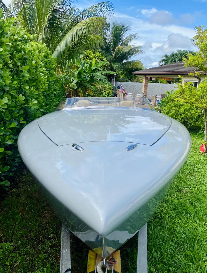 Slide: The Image of 2008 Porsche Fearless 28 boat in a lush garden setting. - 3