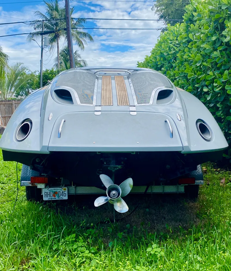 Slide: The Image of 2008 Porsche Fearless 28 boat parked on grass with tropical background. - 4