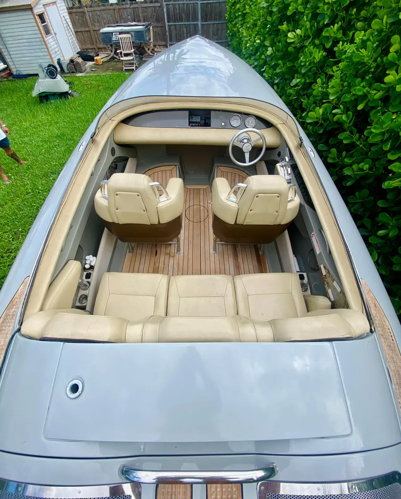 Slide: The Image of 2008 Porsche Fearless 28 boat with beige leather seats and wooden deck. - 6