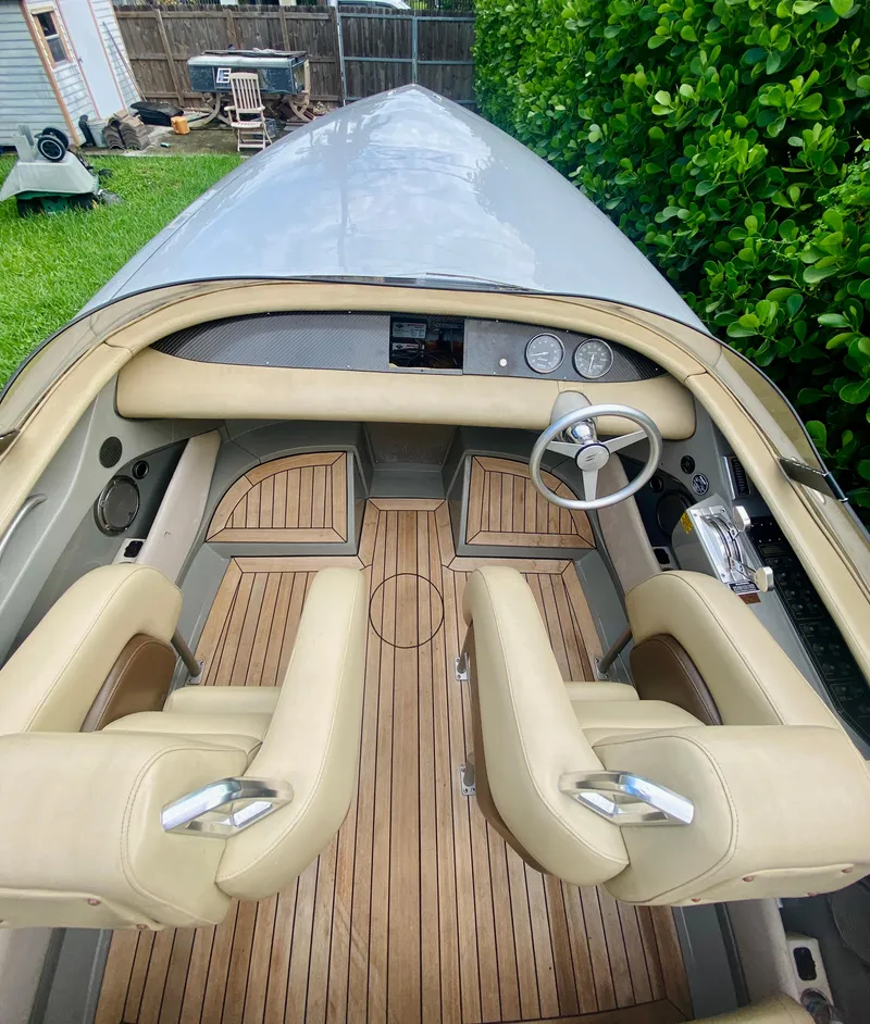 Slide: The Image of 2008 Porsche Fearless 28 boat interior with beige seats and wooden flooring. - 7