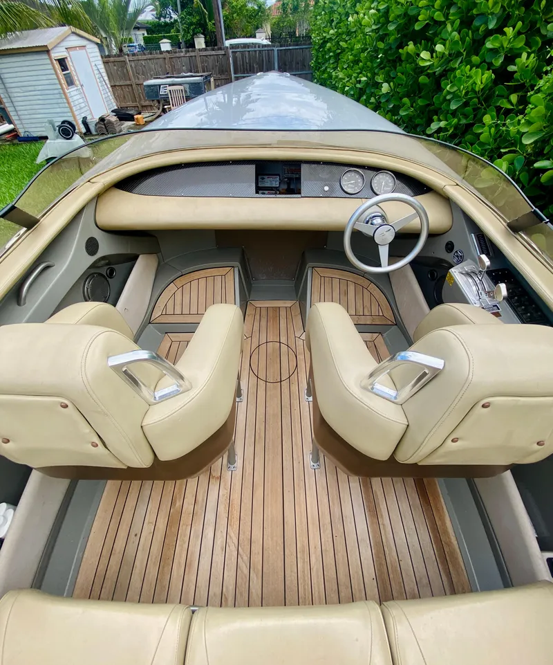 Slide: The Image of 2008 Porsche Fearless 28 boat interior with beige seats and wooden flooring. - 8