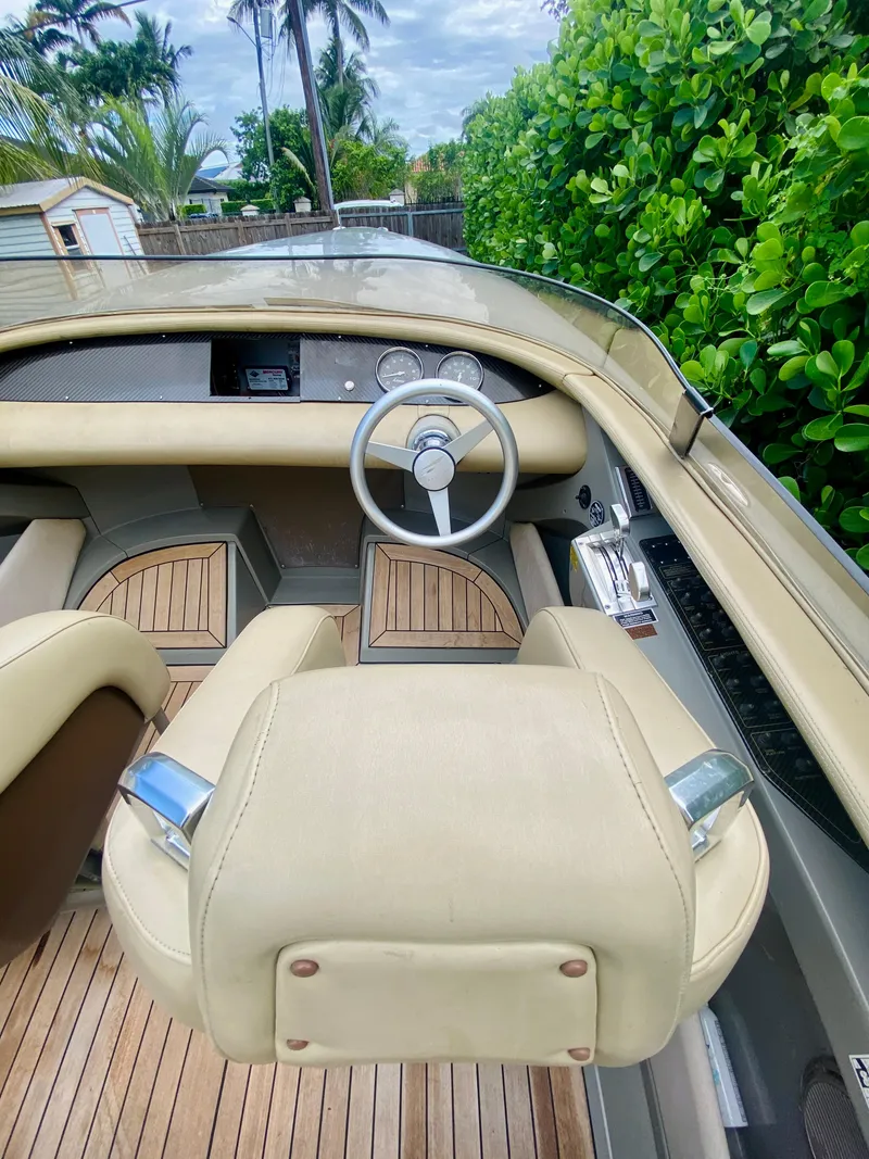 Slide: The Image of 2008 Porsche Fearless 28 boat interior with beige seats and wooden flooring. - 9