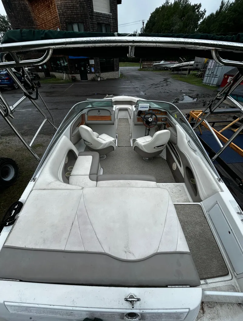 Slide: The Image of 2001 Cobalt 226 boat interior with white seating and steering console. - 10