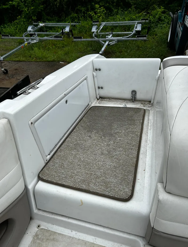 Slide: The Image of 2001 Cobalt 226 boat interior with seating and storage compartment. - 15