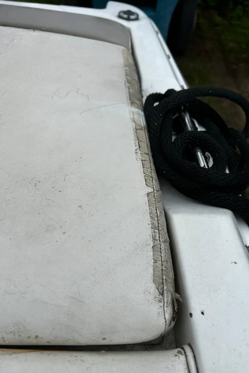 Slide: The Image of Worn seat cushion on a 2001 Cobalt 226 boat with black rope. - 16